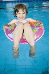 Wall Mural - Happy girl with a float ring