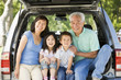 © Monkey Business - Grandparents with grandkids in tailgate of car