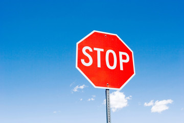 Stop sign against blue sky