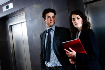 Poster - Businessman and businesswoman reviewing documents