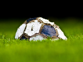 Wall Mural - old soccer ball on grass