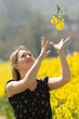 Girl catching yellow flowers