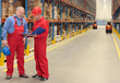 © endostock - standing workers in warehouse reading invoice