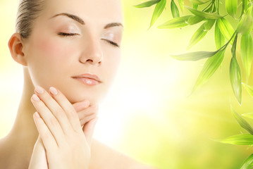 beautiful young woman applying organic cosmetics to her skin