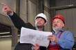© endostock - businessmen and older worker over blueprints
