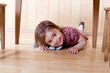 © Igor Stepovik - Happy little girl crawling on the hardwood floor