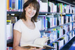 © Monkey Business - Woman reading in a library