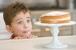 © Monkey Business - Young boy in kitchen looking at cake on counter