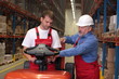 © endostock - A senior worker teaching  junior the operation of a fork lift