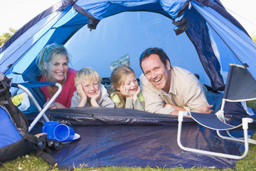 Wall Mural - Family camping in tent smiling