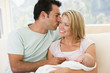 © Monkey Business - Couple in living room with baby smiling