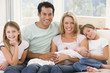 © Monkey Business - Family in living room with baby smiling