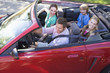 © Monkey Business - Family in convertible car smiling