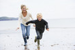 © Monkey Business - Mother and son running on beach