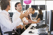 © Monkey Business - Five businesspeople in office space with a ball being thrown