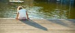 Daydreaming: little girl sitting on the water chilling her feet