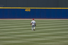 Baseball Player Walking To Outfield