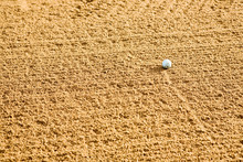 A Golf Ball In A Sand Trap