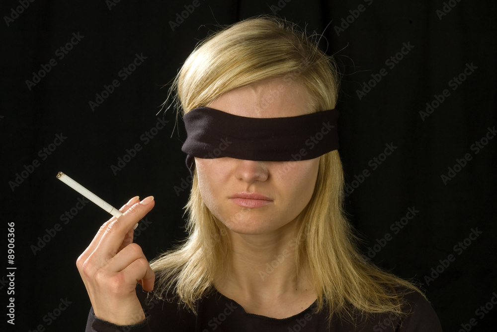 blindfold and a cigarette girl with cigarette in hand and blindfold Stock Photo