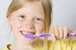 © Hallgerd - Little girl wearing colorful t-shirts brushing teeth