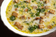 Cheese soup with croutons in a white soup-plate