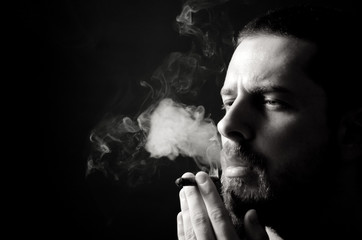 Wall Mural - Black and white portrait of pensive male smoker