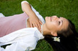 © Adam Borkowski - attractive brunette woman lying on grass