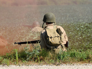 World War II era soldier in a cross fire