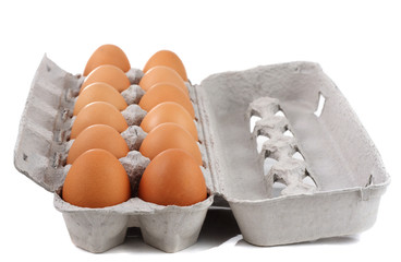 dozen of fresh brown eggs on container