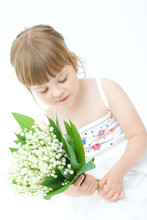 Little, Pretty Girl Holding Bunch Of Lilies Of The Valley