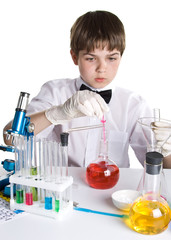 Wall Mural - The boy with a microscope and various colorful flasks