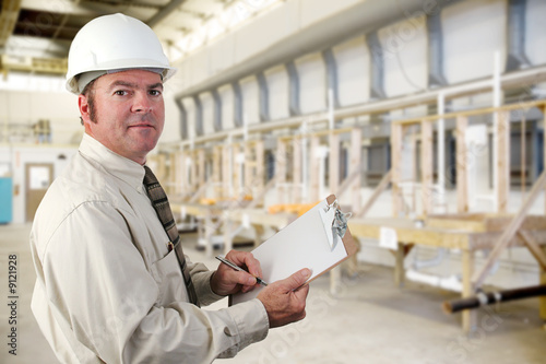 Fotografie, Obraz Inpector performing an audit of a factory.