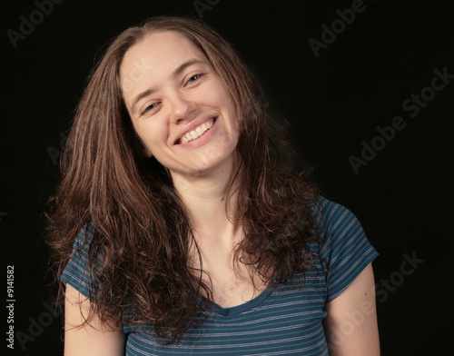 Fototapeta Happy Smiling 20 Year Old Female on Black Background
