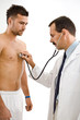 Doctor examining young male patient.