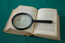 Old Book And Magnifying Glass