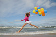 © Gorilla - Teenager jumping with ballons on the beach