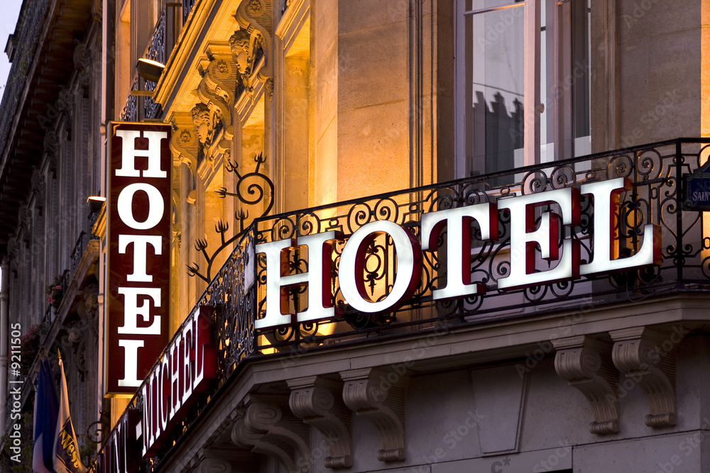 Illuminated Parisian hotel sign taken at dusk - obrazy, fototapety, plakaty 