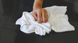 Woman's hand with cotton terry towel wiping stone counter