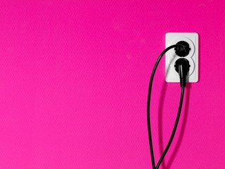 electric oulets on magenta colored wall