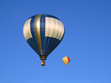 Two Beautiful Hot Air Balloons In The Blue Sky.
