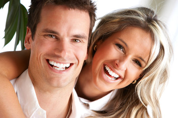 Poster - Young love couple smiling in the comfortable apartment.