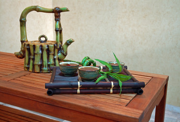 Canvas Print - Chinese tea in antique bowls with bamboo and teapot.