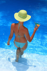 Wall Mural - Woman standing  in blue pool