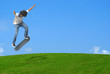 © southmind - Young skater jumping over a green  hill.