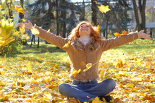 Happy Girl Throwing Autumn Leaves