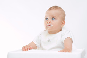 Poster - baby boy with dirty face sitting in highchair