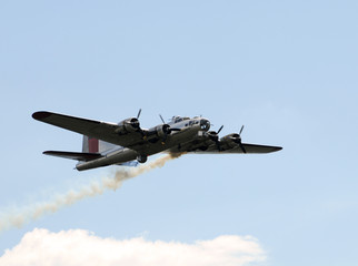 Sticker - World War II era Flying Fortress bomber with smoke trail