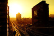 Leinwandbild Motiv Sun sets over a busy Santiago cityscape