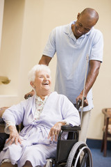 Wall Mural - Nurse Pushing Senior Woman In Wheelchair