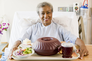 Wall Mural - Senior Woman Sitting In Hospital Bed With A Tray Of Food